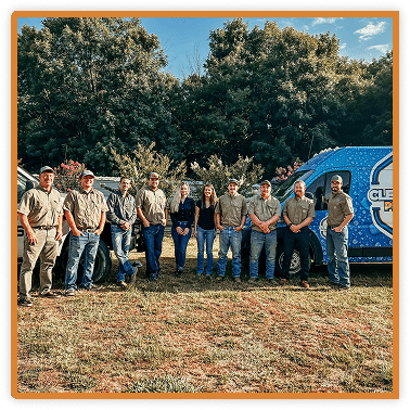 company group picture in front of vans